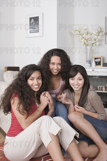 Portrait of three young women smiling. Photo : Rob Lewine