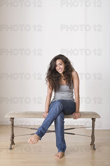 Young woman sitting on bench. Photo: Rob Lewine
