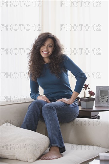 Woman relaxing on sofa. Photo : Rob Lewine