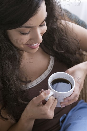 Woman relaxing with cup of coffee. Photo: Rob Lewine