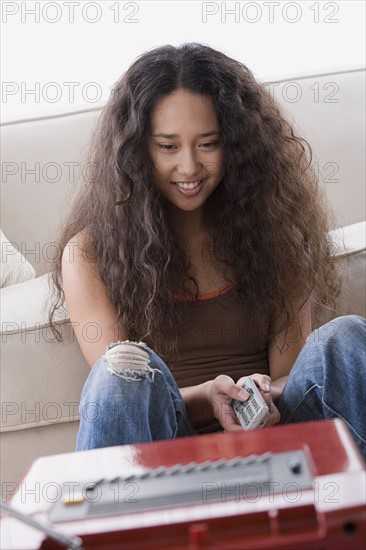 Young woman watching tv. Photo: Rob Lewine