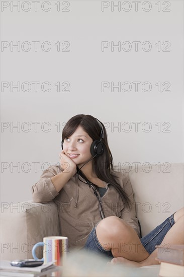 Woman relaxing on sofa. Photo : Rob Lewine