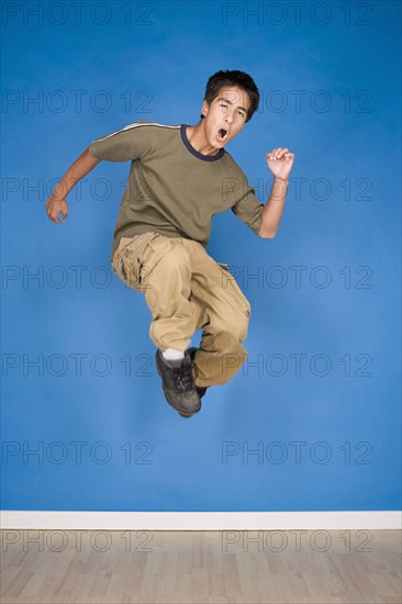 Portrait of teenage boy (16-17) jumping. Photo: Rob Lewine