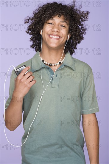 Portrait of teenage boy (14-15) listening music. Photo: Rob Lewine