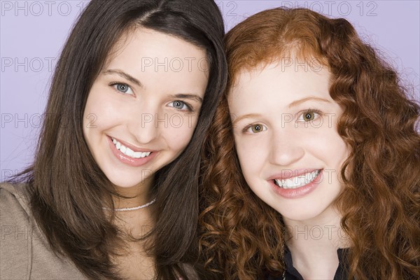 Portrait of two teenage girls (16-17) standing together. Photo : Rob Lewine