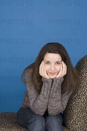 Portrait of teenage girl (16-17) sitting. Photo : Rob Lewine