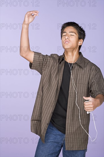 Portrait of teenage boy (16-17) listening music. Photo: Rob Lewine