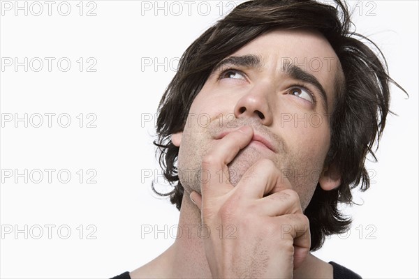 Portrait of young man contemplating. Photo : Rob Lewine