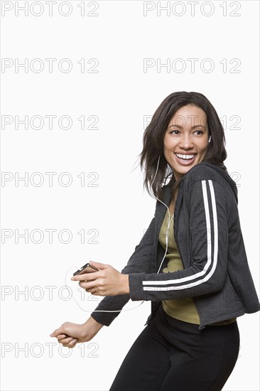 Studio portrait of young woman listening music. Photo: Rob Lewine