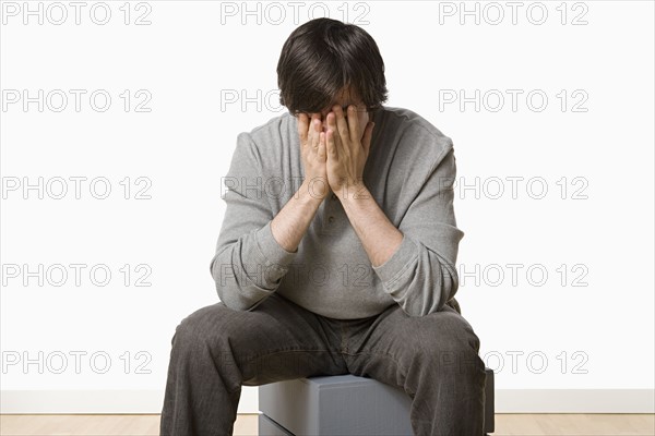 Studio portrait of young man crying. Photo : Rob Lewine