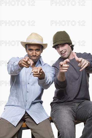 Studio portrait of two young men playing. Photo : Rob Lewine