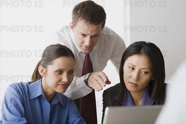 Three people working in office. Photo: Rob Lewine