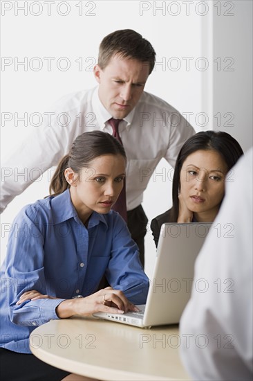 Three people working in office. Photo : Rob Lewine