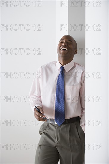 Portrait of businessman laughing. Photo: Rob Lewine