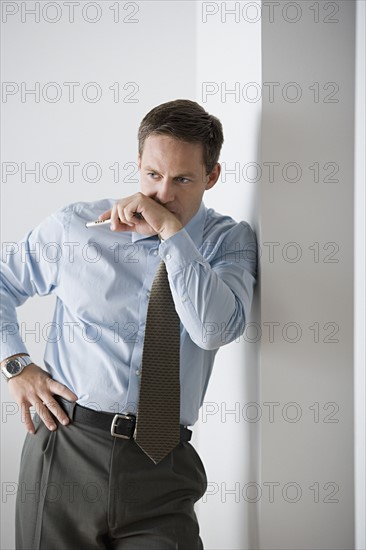 Portrait of businessman standing. Photo : Rob Lewine