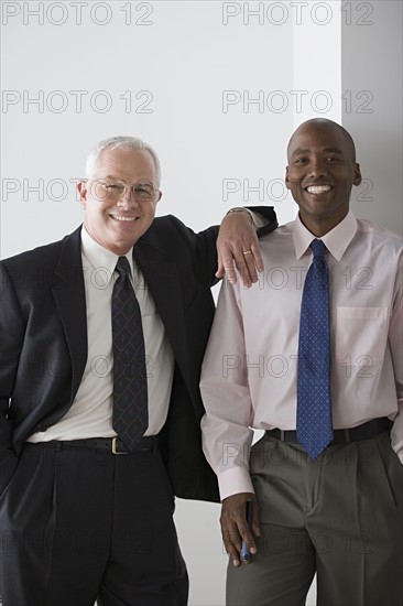 Two businessmen smiling. Photo : Rob Lewine