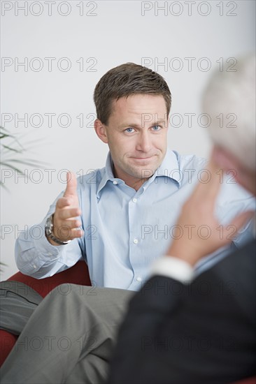 Two businessmen talking. Photo : Rob Lewine