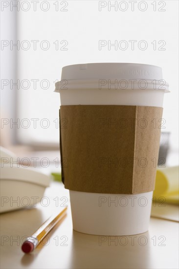 Plastic coffee cup on desk. Photo : Rob Lewine