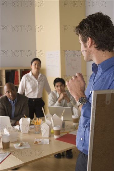 Group businesspeople brainstorming. Photo : Rob Lewine