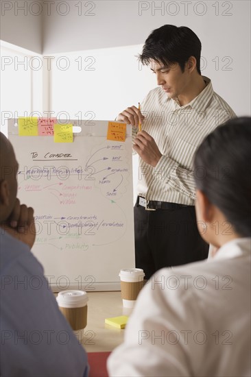 Group of businesspeople in meeting. Photo : Rob Lewine