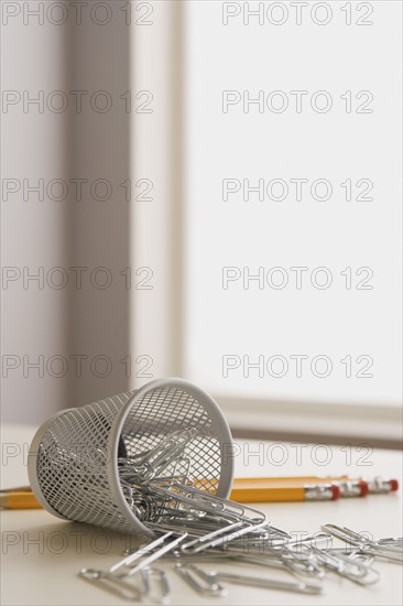 Paper clips pencils and small metal basket. Photo : Rob Lewine