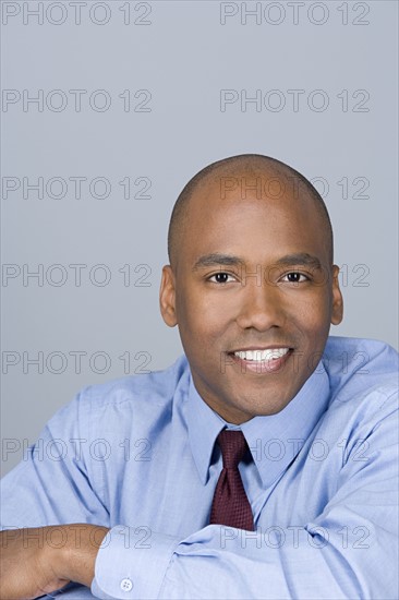 Portrait of happy mid adult businessman. Photo: Rob Lewine