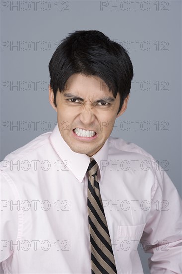 Portrait of young businessman pulling funny faces. Photo: Rob Lewine