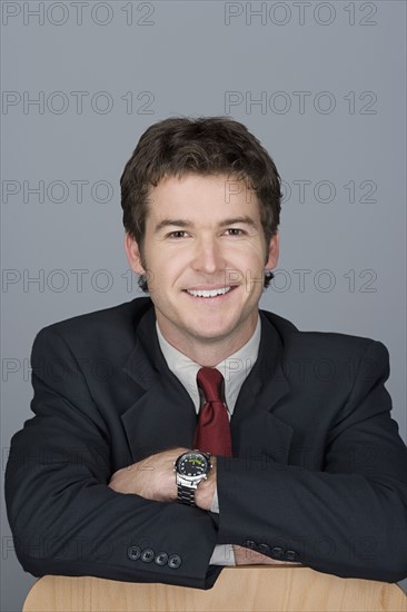 Portrait of happy young businessman. Photo : Rob Lewine