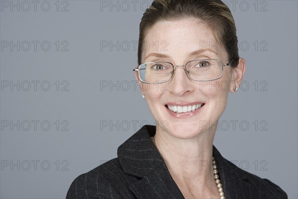 Portrait of cheerful mature businesswoman. Photo : Rob Lewine