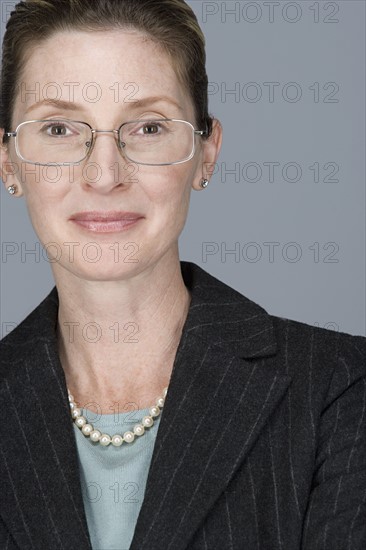 Portrait of cheerful mature businesswoman. Photo : Rob Lewine