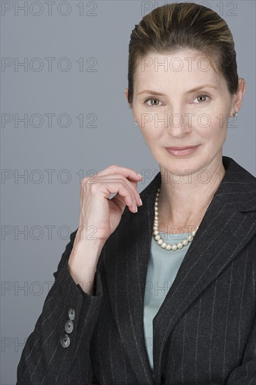 Portrait of cheerful mature businesswoman. Photo : Rob Lewine