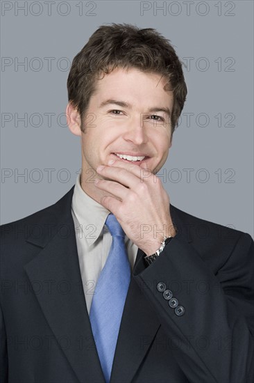 Portrait of happy young businessman. Photo : Rob Lewine