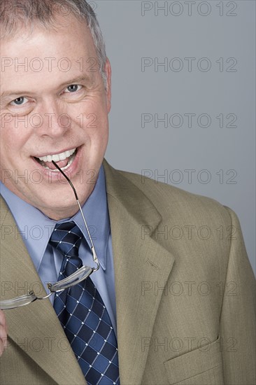 Portrait of happy mature businessman. Photo: Rob Lewine