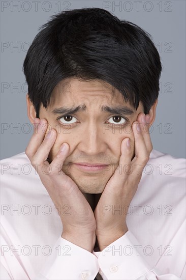 Portrait of unhappy young businessman. Photo : Rob Lewine