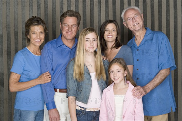 Portrait of happy three-generation family with two girls (8-9, 14-15). Photo : Rob Lewine