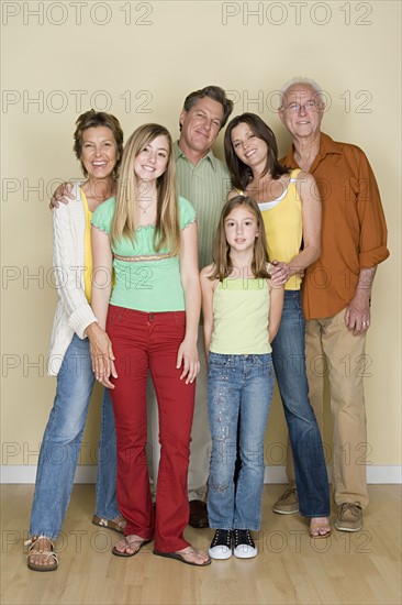 Portrait of happy three-generation family with two girls (8-9, 14-15). Photo : Rob Lewine