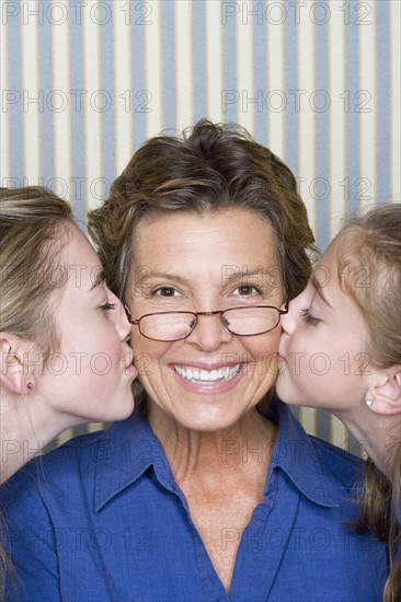 Portrait of father being kissed by two girls (8-9, 14-15) . Photo : Rob Lewine