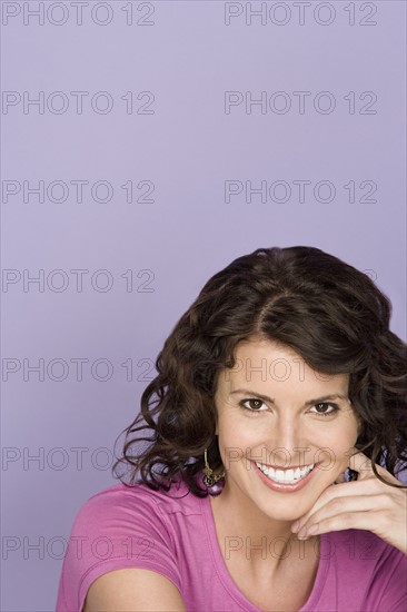 Portrait of happy mid adult woman wearing pink top. Photo : Rob Lewine