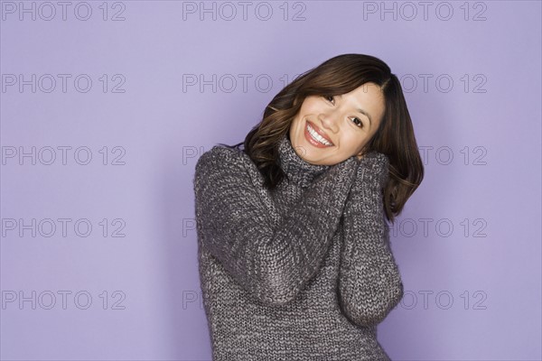 Portrait of happy asian woman wearing wooly jumper. Photo: Rob Lewine