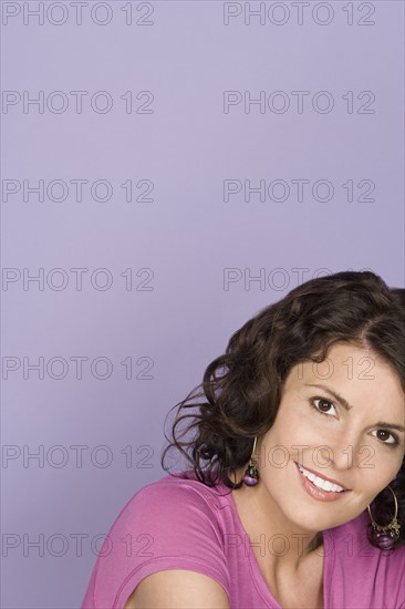 Portrait of happy mid adult woman wearing pink top. Photo : Rob Lewine