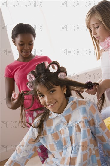 Three girls (10-11) having fun at slumber party. Photo: Rob Lewine