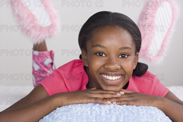 Portrait of smiling girl (10-11) in pajamas. Photo: Rob Lewine