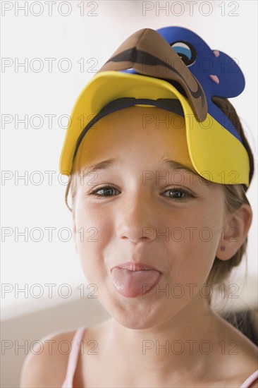 Portrait of smiling girl (10-11) sticking out tongue. Photo : Rob Lewine