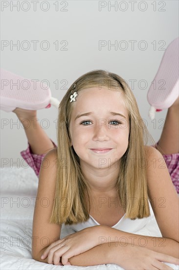 Portrait of smiling girl (10-11) in pajamas. Photo: Rob Lewine