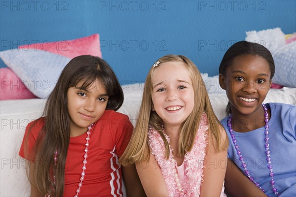 Portrait of three girls (10-11) at slumber party. Photo: Rob Lewine