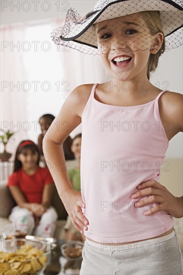 Portrait of girl (10-11) wearing hat with veil at slumber party. Photo: Rob Lewine