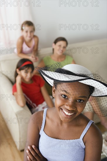 Portrait of girl (10-11) wearing hat with veil at slumber party. Photo: Rob Lewine