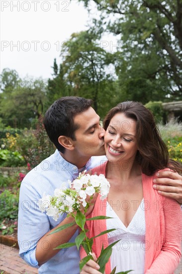 Happy couple in garden. Photo: Tetra Images