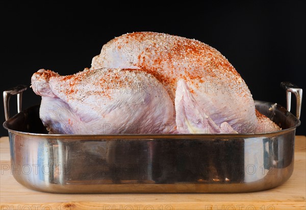 Raw turkey on roasting pan.