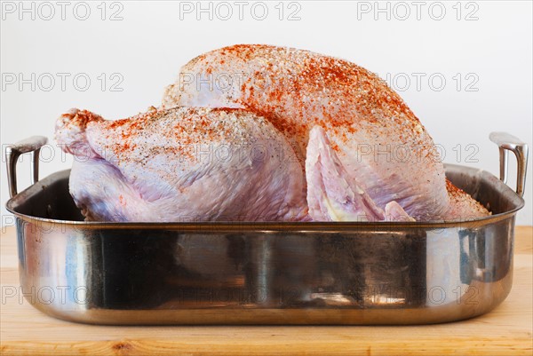 Raw turkey on roasting pan.